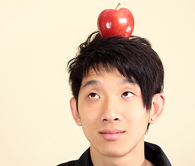 Image showing young man with an apple on his head 