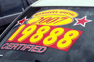 Image showing price sticker on used car lot