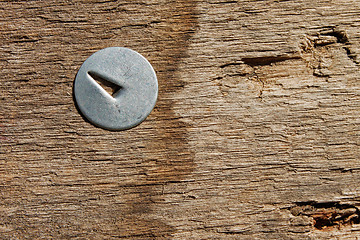 Image showing Metal pin in wooden board