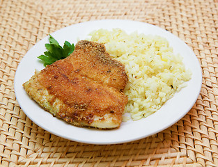 Image showing fried breaded tilapia served with rice and herbs