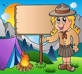 Image showing Scout girl holding board outdoor