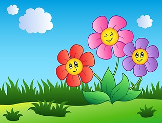 Image showing Three cartoon flowers on meadow