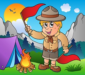 Image showing Scout boy with flags outdoor