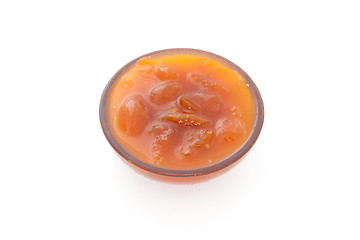 Image showing Orange confiture in a jar. isolated on a white