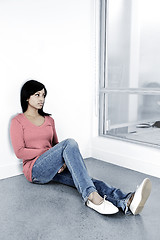 Image showing Depressed woman sitting on the floor