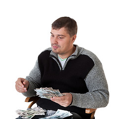 Image showing A young man finds money