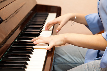 Image showing Hands of a young girl playing the piano