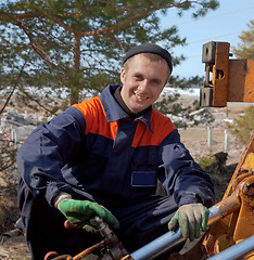 Image showing Machinist excavator with a wrench in his hand