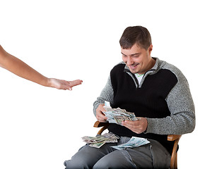 Image showing Happy young man counts the money