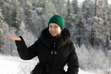 Image showing A girl in a black coat with fur collar 