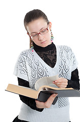 Image showing Girl with glasses reading a book