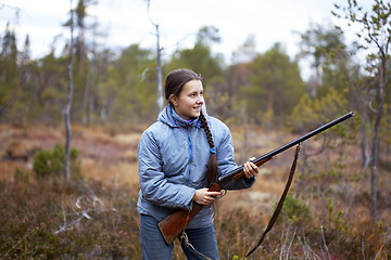 Image showing Girl with shotgun