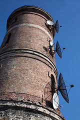 Image showing Modern communications antenna on an old tower