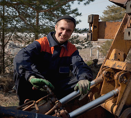 Image showing Machinist excavator with a wrench in his hand