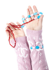 Image showing The hands of girls showing glass ornaments