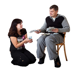 Image showing Young couple holding money on white background