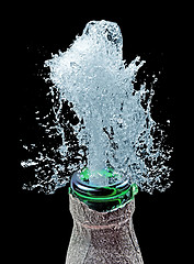 Image showing bottle and water splash on black