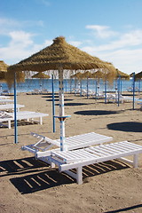 Image showing sunbeds and parasols