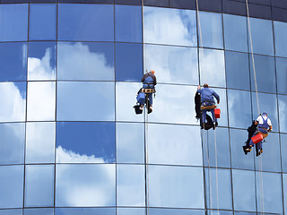 Image showing Workers washing a skyscraper windows