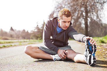 Image showing Mixed race man stretching