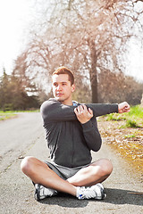 Image showing Mixed race man stretching