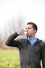 Image showing Mixed race man drinking water