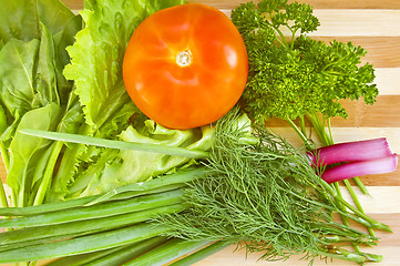 Image showing Tomatoes with herbs on the board