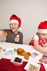 Image showing Girls decorating gingerbread cookies