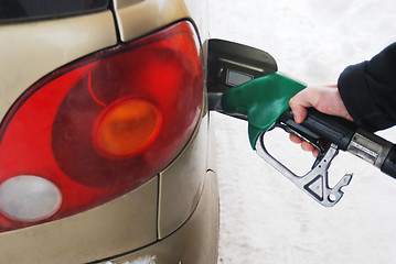 Image showing close-up of a man's hand using a petrol pump