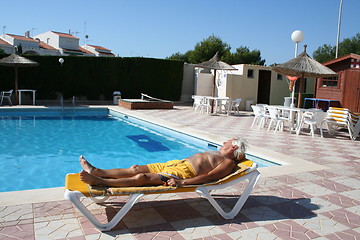 Image showing Man beside swimmingpool