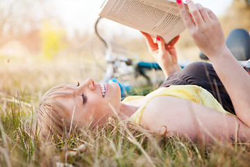 Image showing Beautiful Caucasian woman reading outdoor