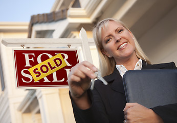 Image showing Real Estate Agent with Keys in Front of Sold Sign and House