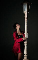 Image showing young woman and lightpole