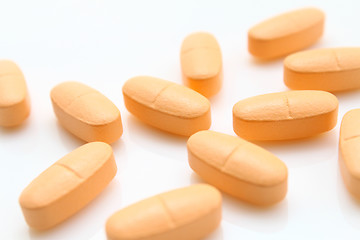 Image showing orange pills over white 