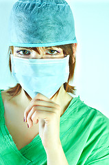 Image showing Woman surgeon holding her chin and has a serious look on her fac