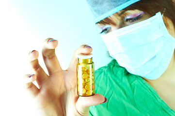 Image showing Doctor holding a bottle of pills in her hand 