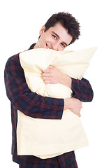 Image showing Man in pajamas holding pillow