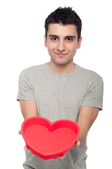 Image showing Casual man holding heart