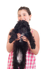 Image showing Girl holding dog