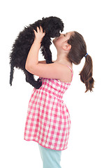 Image showing Girl kissing dog