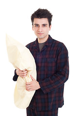 Image showing Man in pajamas holding pillow