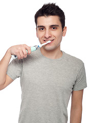 Image showing Young man brushing teeth