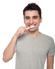 Image showing Young man brushing teeth