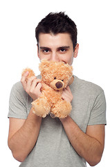 Image showing Man cuddling teddy bear