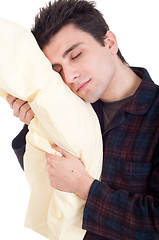 Image showing Man in pajamas holding pillow