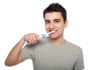 Image showing Young man brushing teeth