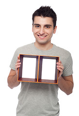 Image showing Man holding frame
