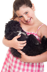 Image showing Girl holding dog