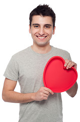 Image showing Casual man holding heart