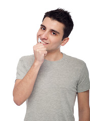 Image showing Young man brushing teeth